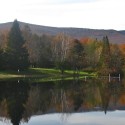 A lake with trees in the background and mountains